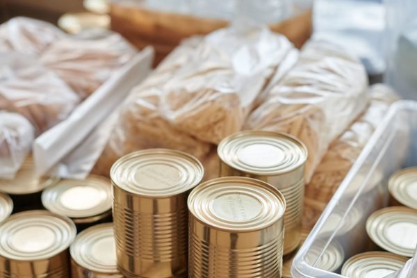 pexels photo 6994962 6994962 A variety of canned goods and packaged items arranged for a donation drive or food bank collection.